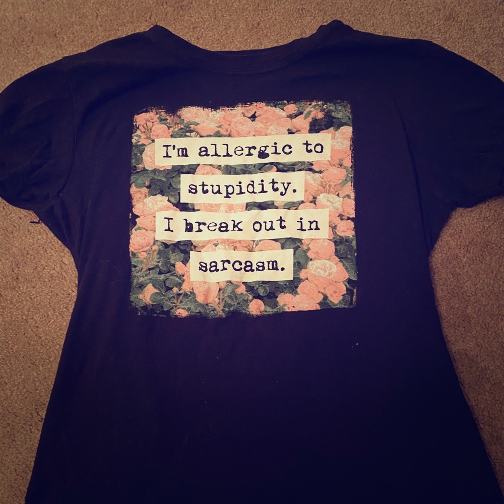 A black shirt with a quote in the middle